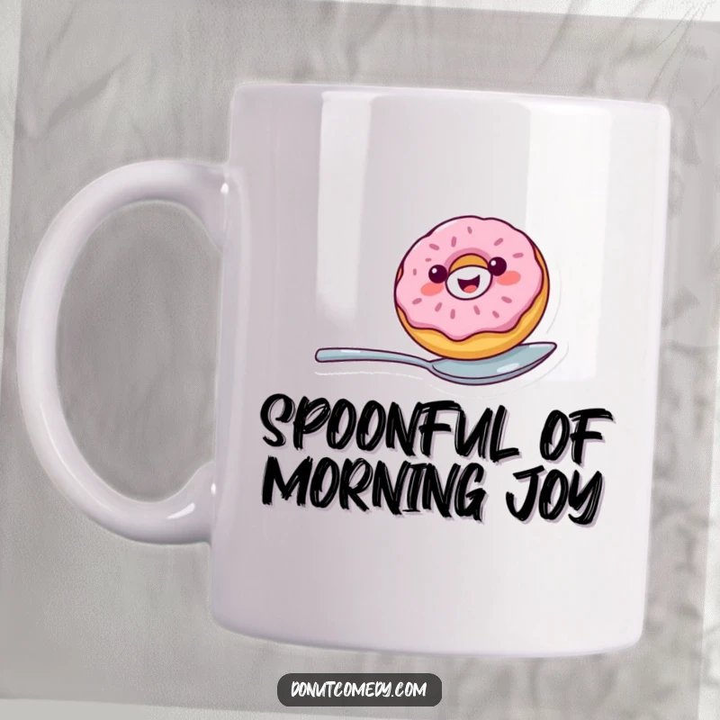 Funny mug showcasing a cheerful donut with a wide smile expertly balancing on a spoon, a delightful and humorous gift.