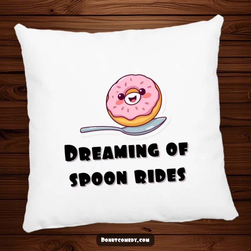 Funny decorative pillow featuring a cheerful donut balancing on a spoon, providing comfort and a humorous visual element.