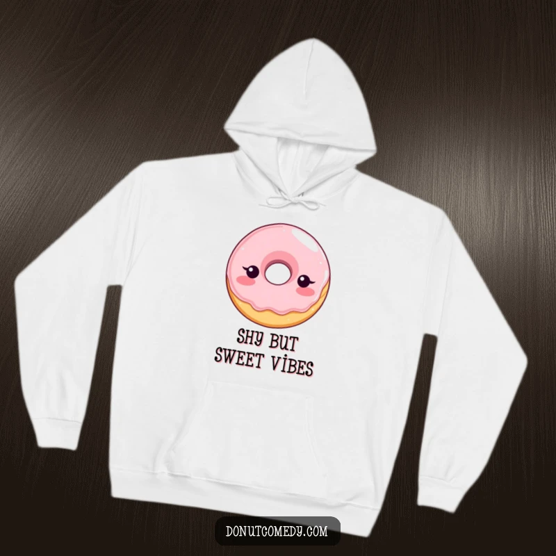 Funny hoodie showcasing a shy, blushing glazed donut character, radiating bashful cuteness, a perfect humorous and cozy gift.